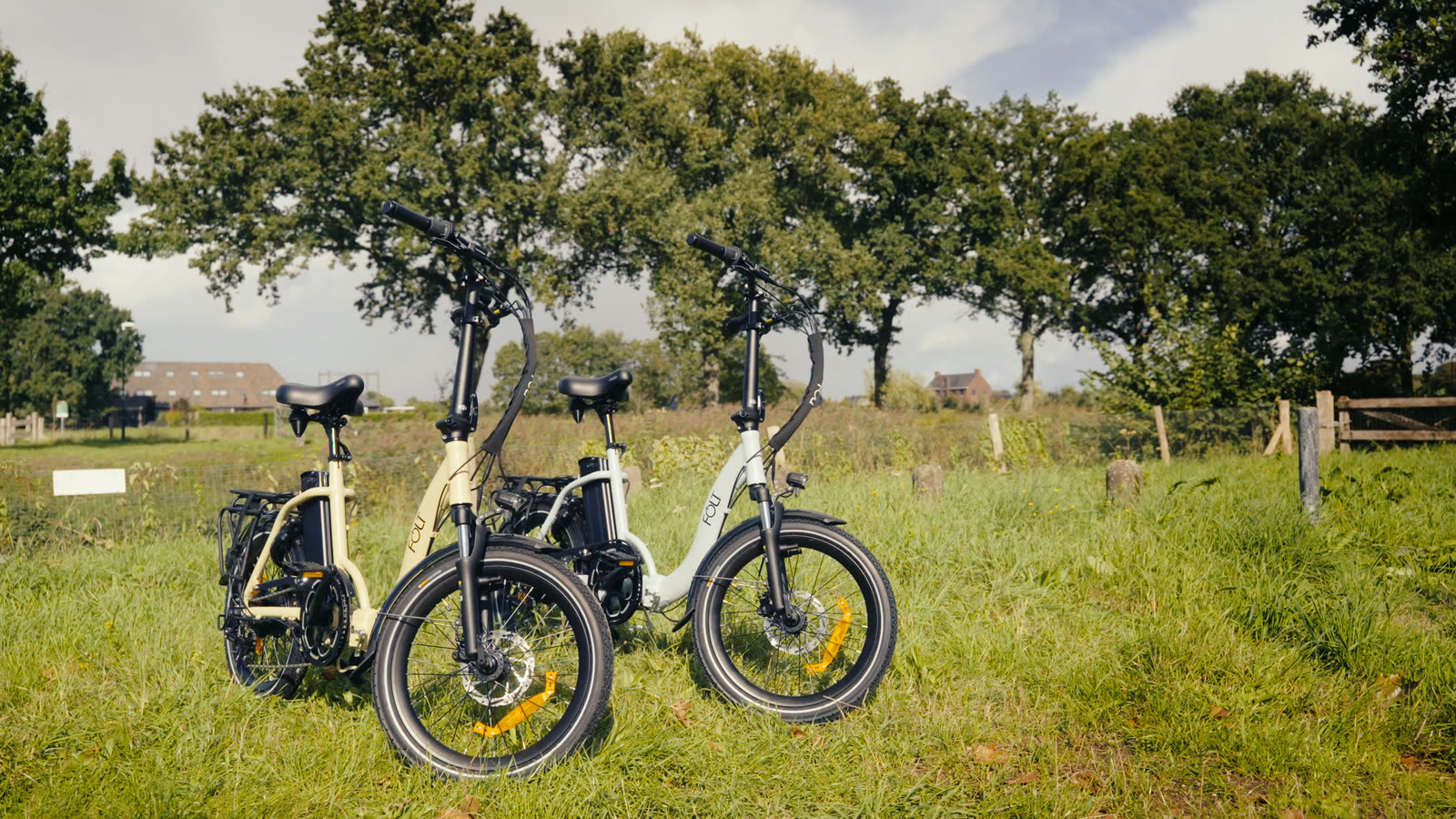 Drie FOLT elektrische vouwfietsen op een grasveld